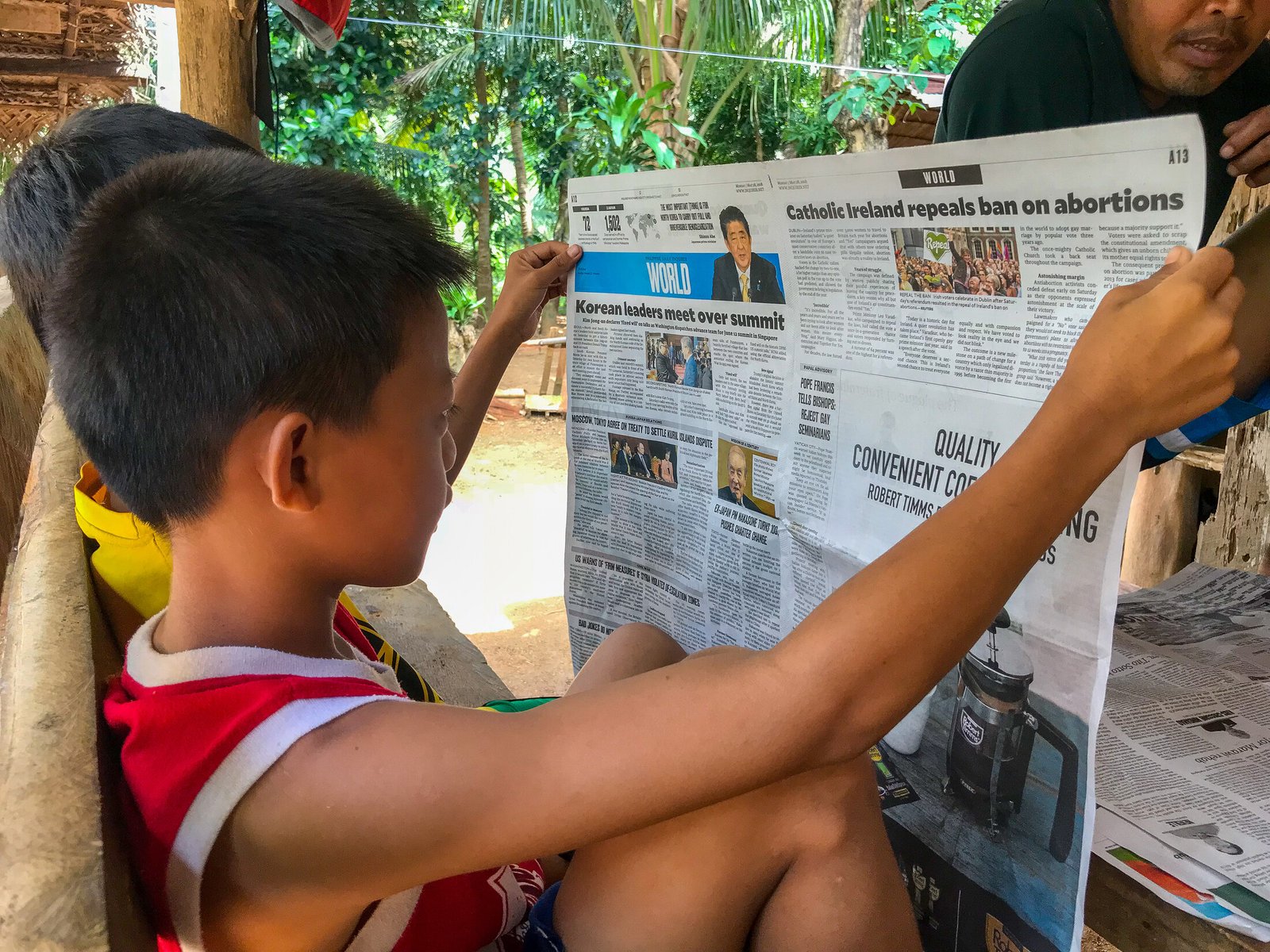 A child reading a local project sign