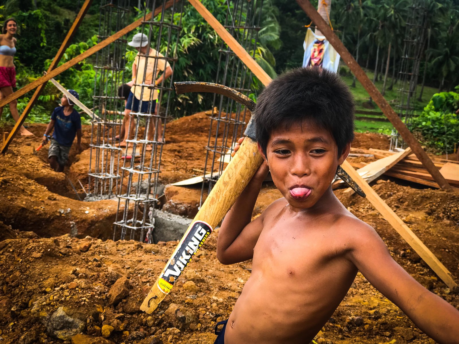 Boy carrying sticks during fieldwork