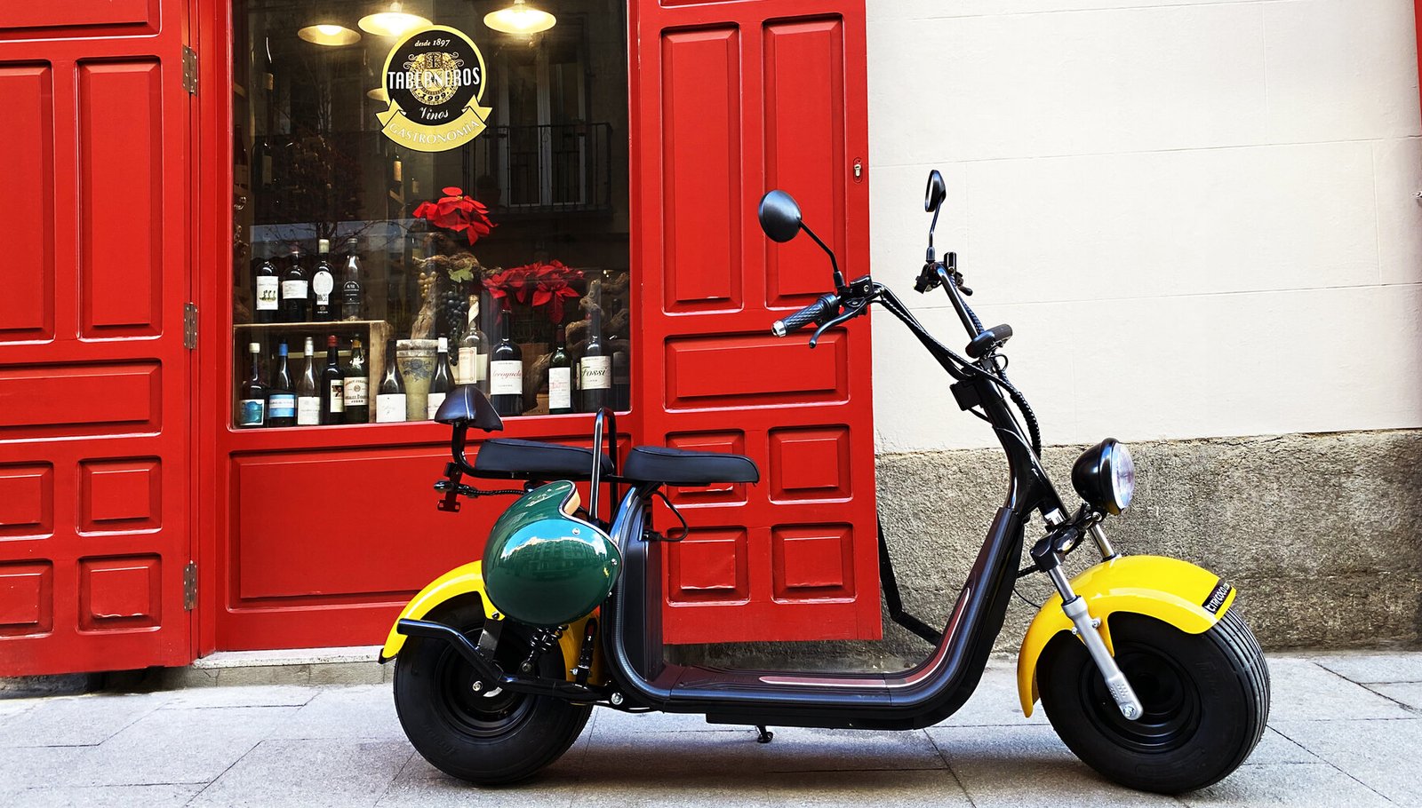 Citycoco scooter against red doors in Madrid